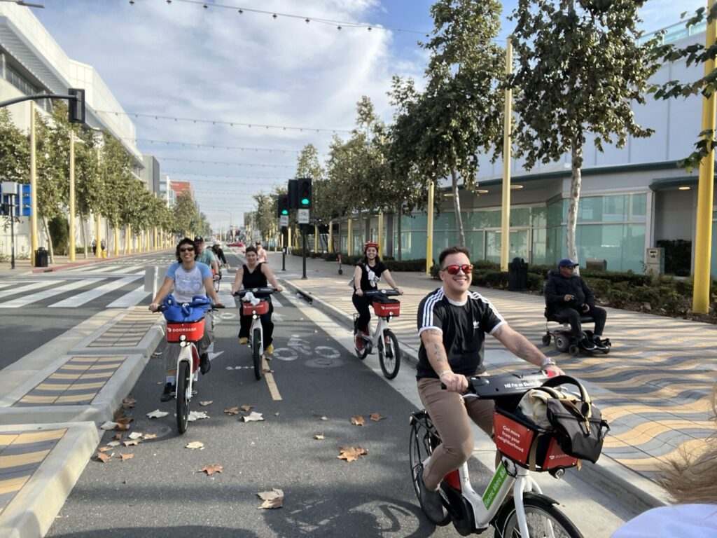 Four people riding bikes on a two-way protected bike lane in Santa Monica
