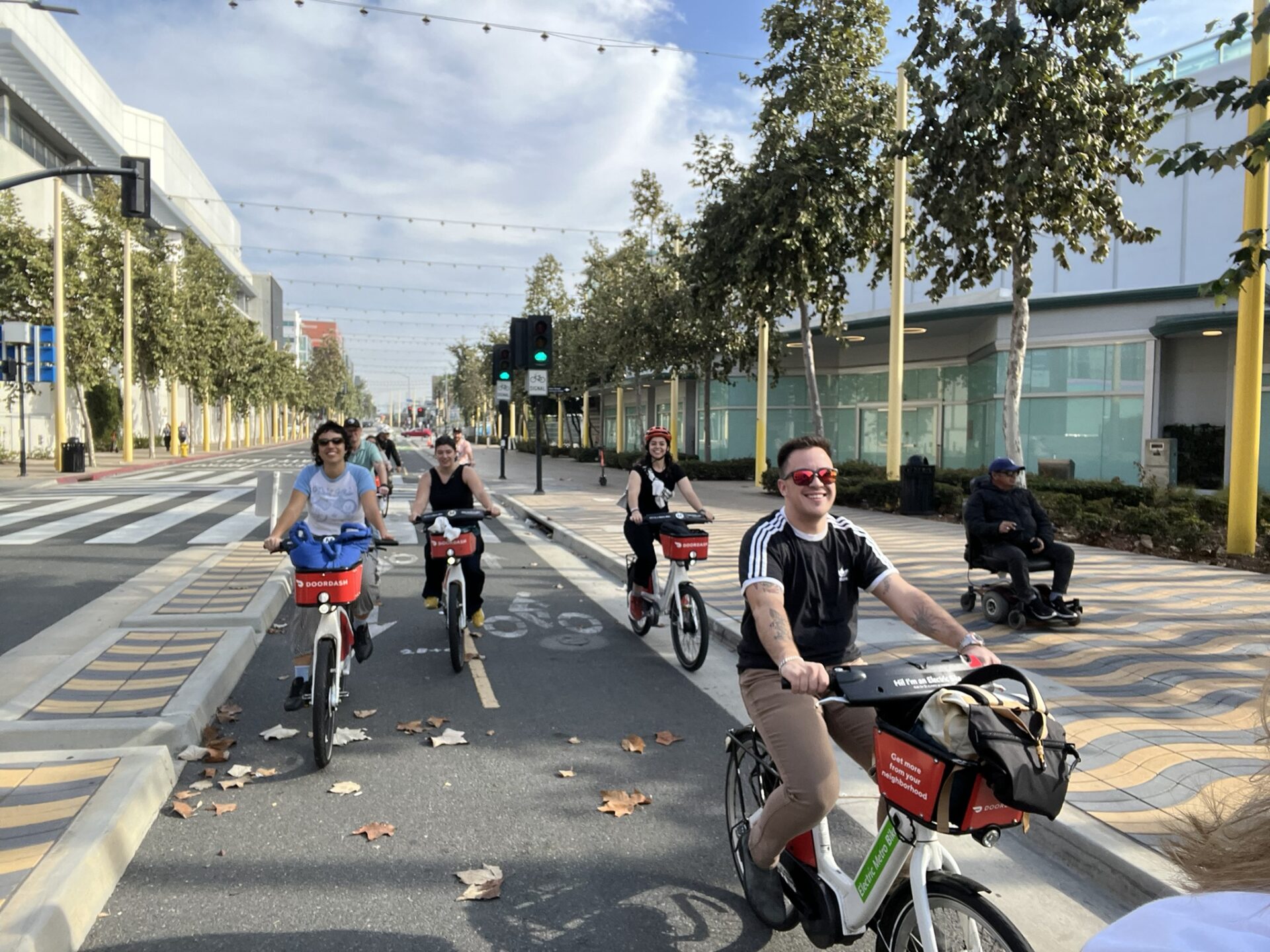 Four people riding bikes on a two-way protected bike lane in Santa Monica