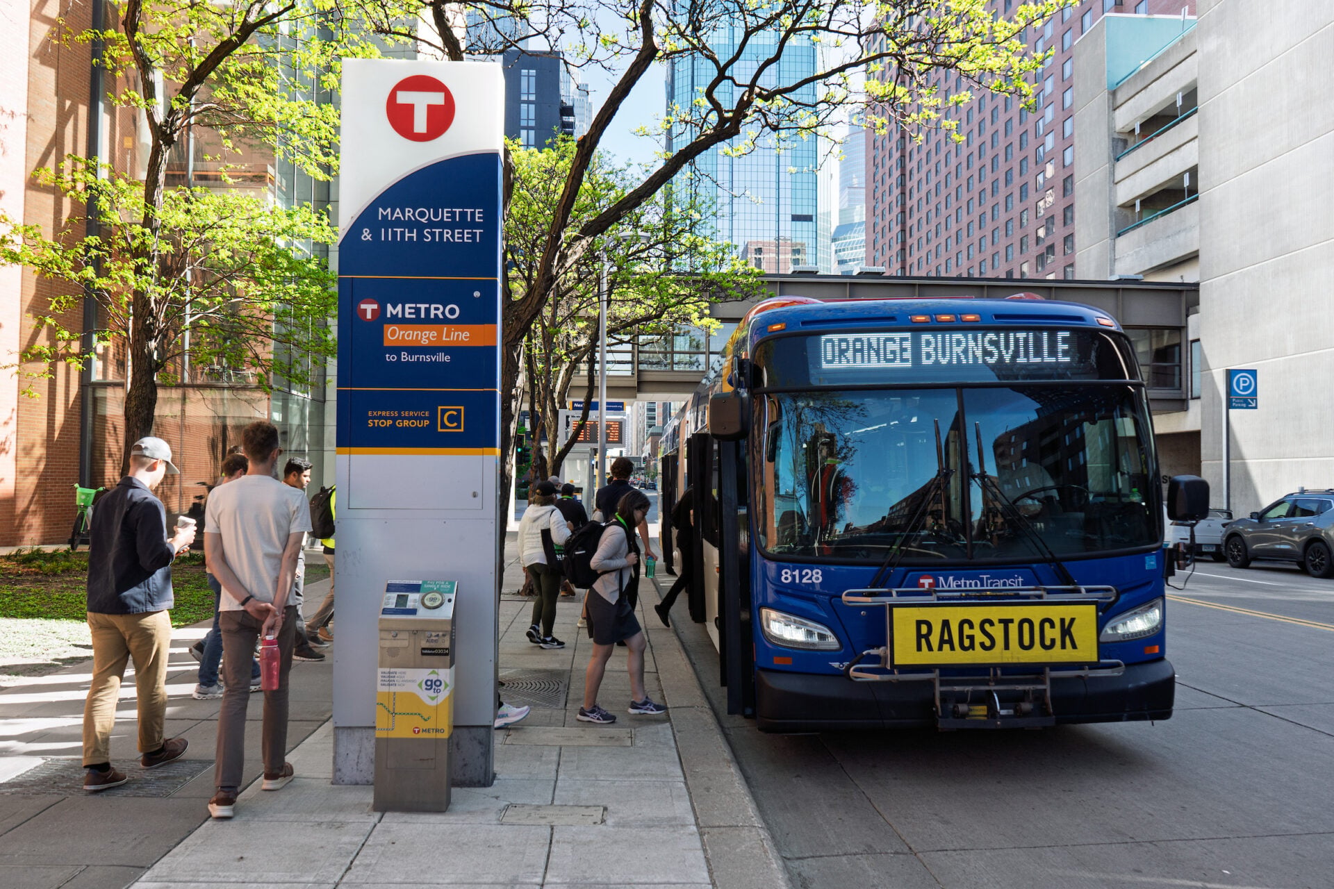 Passengers board a bus in Minneapolis.