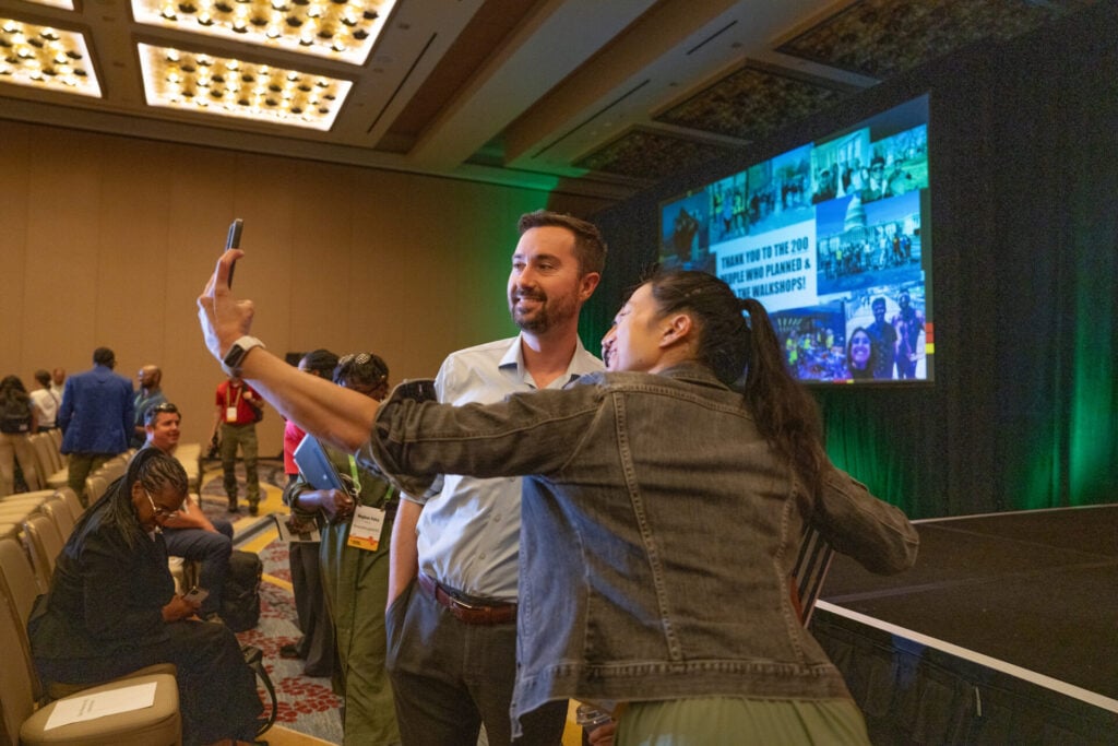 Attendees take selfies together at Designing Cities 2025 in Washington DC