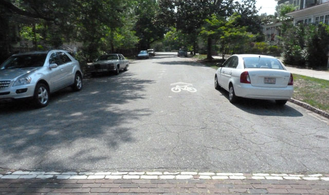 Shared Lane Marking - Wilmington, NCOn the Ann Street Bicycle Boulevard the shared lane markings identify the bicycle priority of the street and direct bicyclists to ride outside of the door zone. 